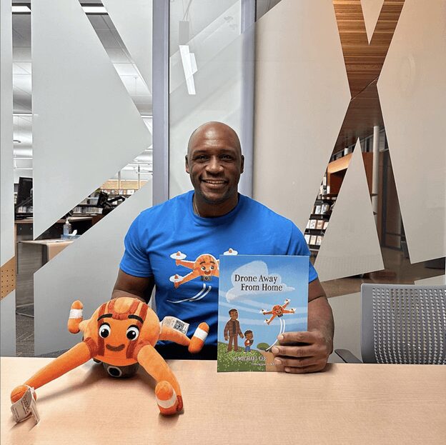 Author holding book and plushie